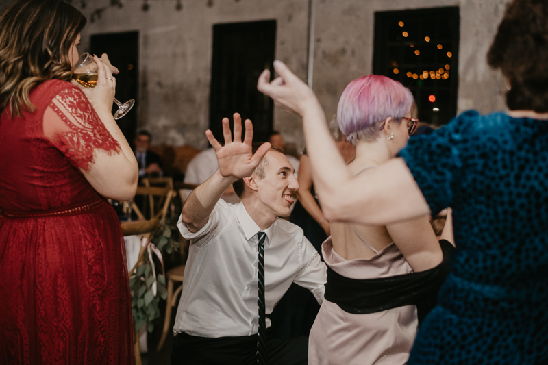 A bright and light filled evening wedding reception by District Remix DJs at the Mt. Washington Mill Dye House in Baltimore, Maryland by Britney Clause Photography