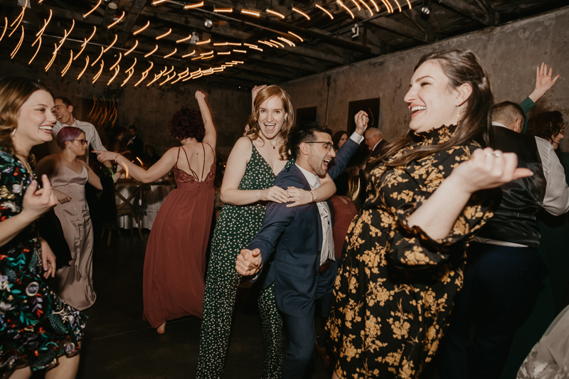 A bright and light filled evening wedding reception by District Remix DJs at the Mt. Washington Mill Dye House in Baltimore, Maryland by Britney Clause Photography