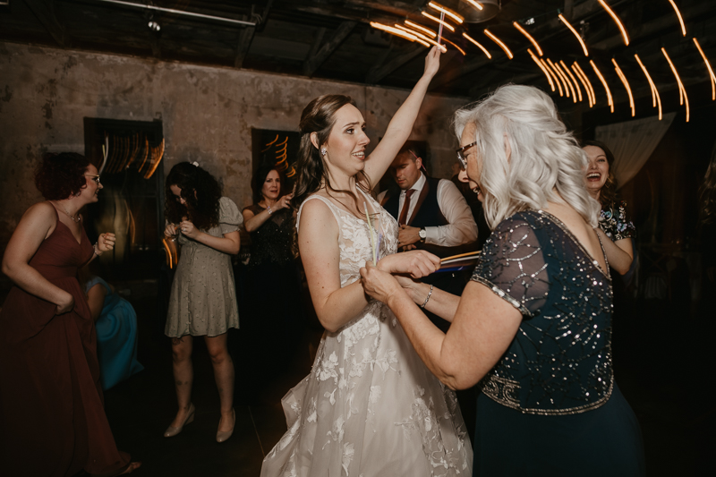 A bright and light filled evening wedding reception by District Remix DJs at the Mt. Washington Mill Dye House in Baltimore, Maryland by Britney Clause Photography