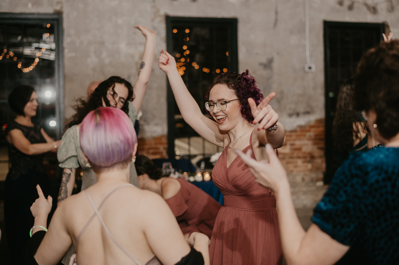 A bright and light filled evening wedding reception by District Remix DJs at the Mt. Washington Mill Dye House in Baltimore, Maryland by Britney Clause Photography