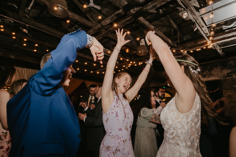 A bright and light filled evening wedding reception by District Remix DJs at the Mt. Washington Mill Dye House in Baltimore, Maryland by Britney Clause Photography