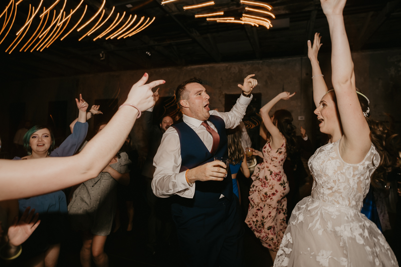 A bright and light filled evening wedding reception by District Remix DJs at the Mt. Washington Mill Dye House in Baltimore, Maryland by Britney Clause Photography