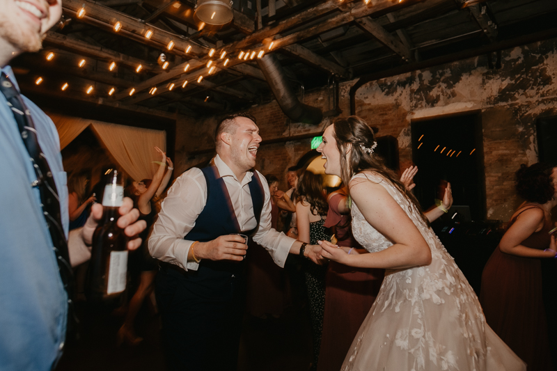 A bright and light filled evening wedding reception by District Remix DJs at the Mt. Washington Mill Dye House in Baltimore, Maryland by Britney Clause Photography