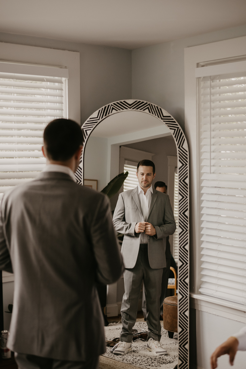 A groom getting ready at a private residence for an Annapolis Waterfront Hotel Wedding in Annapolis, Maryland by Britney Clause Photography