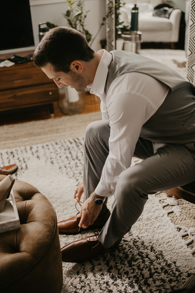 A groom getting ready at a private residence for an Annapolis Waterfront Hotel Wedding in Annapolis, Maryland by Britney Clause Photography