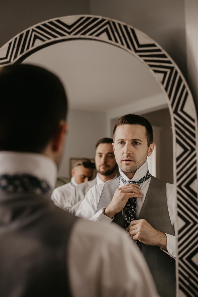 A groom getting ready at a private residence for an Annapolis Waterfront Hotel Wedding in Annapolis, Maryland by Britney Clause Photography