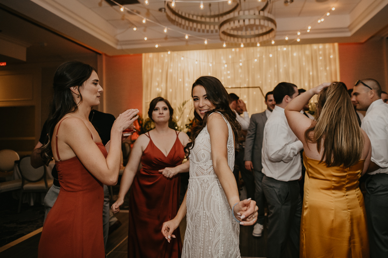 An exciting evening wedding reception by Toussaint Productions at the Annapolis Waterfront Hotel in Annapolis, Maryland by Britney Clause Photography