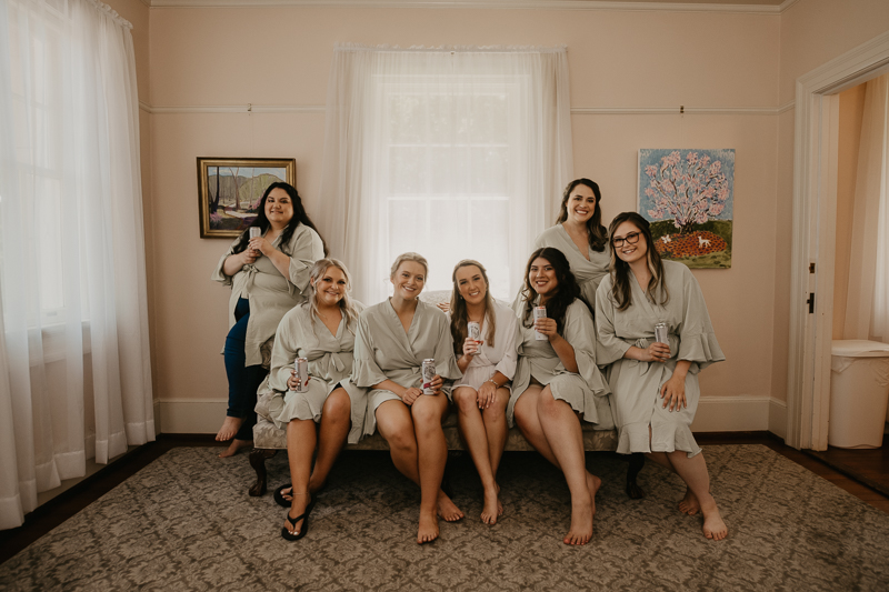 A bride getting ready with hair and makeup by Swept LLC at the Liriodendron Mansion in Bel Air, Maryland by Britney Clause Photography