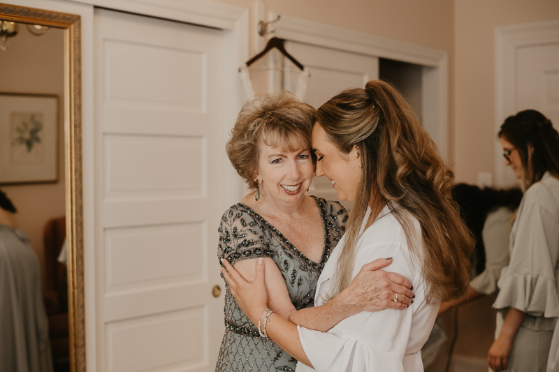 A bride getting ready with hair and makeup by Swept LLC at the Liriodendron Mansion in Bel Air, Maryland by Britney Clause Photography