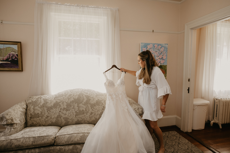 A bride getting ready with hair and makeup by Swept LLC at the Liriodendron Mansion in Bel Air, Maryland by Britney Clause Photography