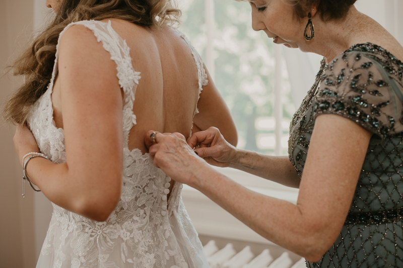 A bride getting ready with hair and makeup by Swept LLC at the Liriodendron Mansion in Bel Air, Maryland by Britney Clause Photography