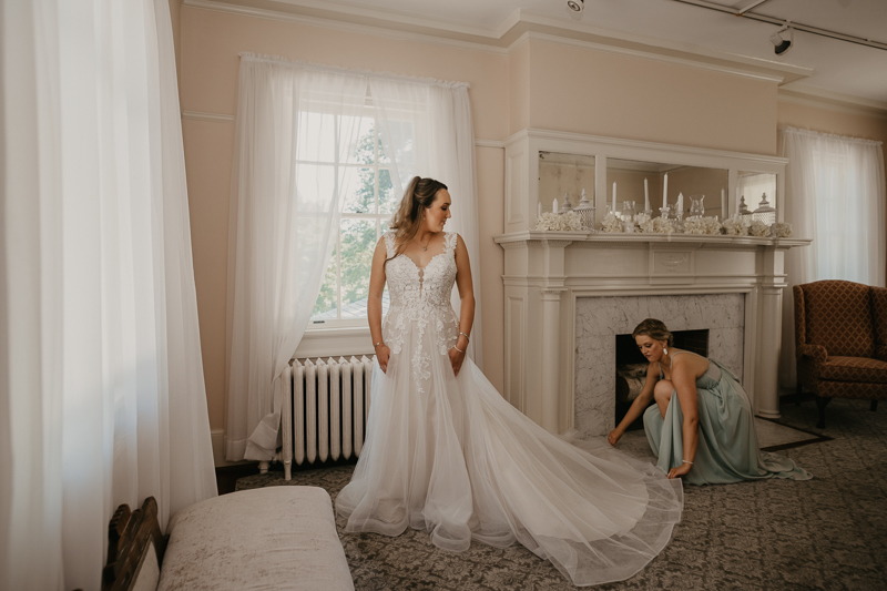 A bride getting ready with hair and makeup by Swept LLC at the Liriodendron Mansion in Bel Air, Maryland by Britney Clause Photography
