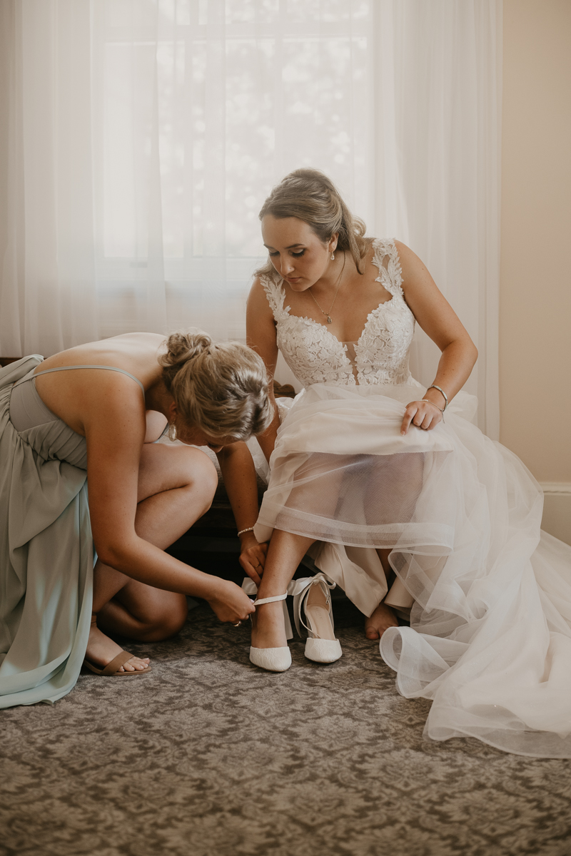 A bride getting ready with hair and makeup by Swept LLC at the Liriodendron Mansion in Bel Air, Maryland by Britney Clause Photography