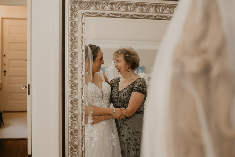 A bride getting ready with hair and makeup by Swept LLC at the Liriodendron Mansion in Bel Air, Maryland by Britney Clause Photography