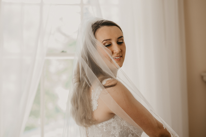 A bride getting ready with hair and makeup by Swept LLC at the Liriodendron Mansion in Bel Air, Maryland by Britney Clause Photography