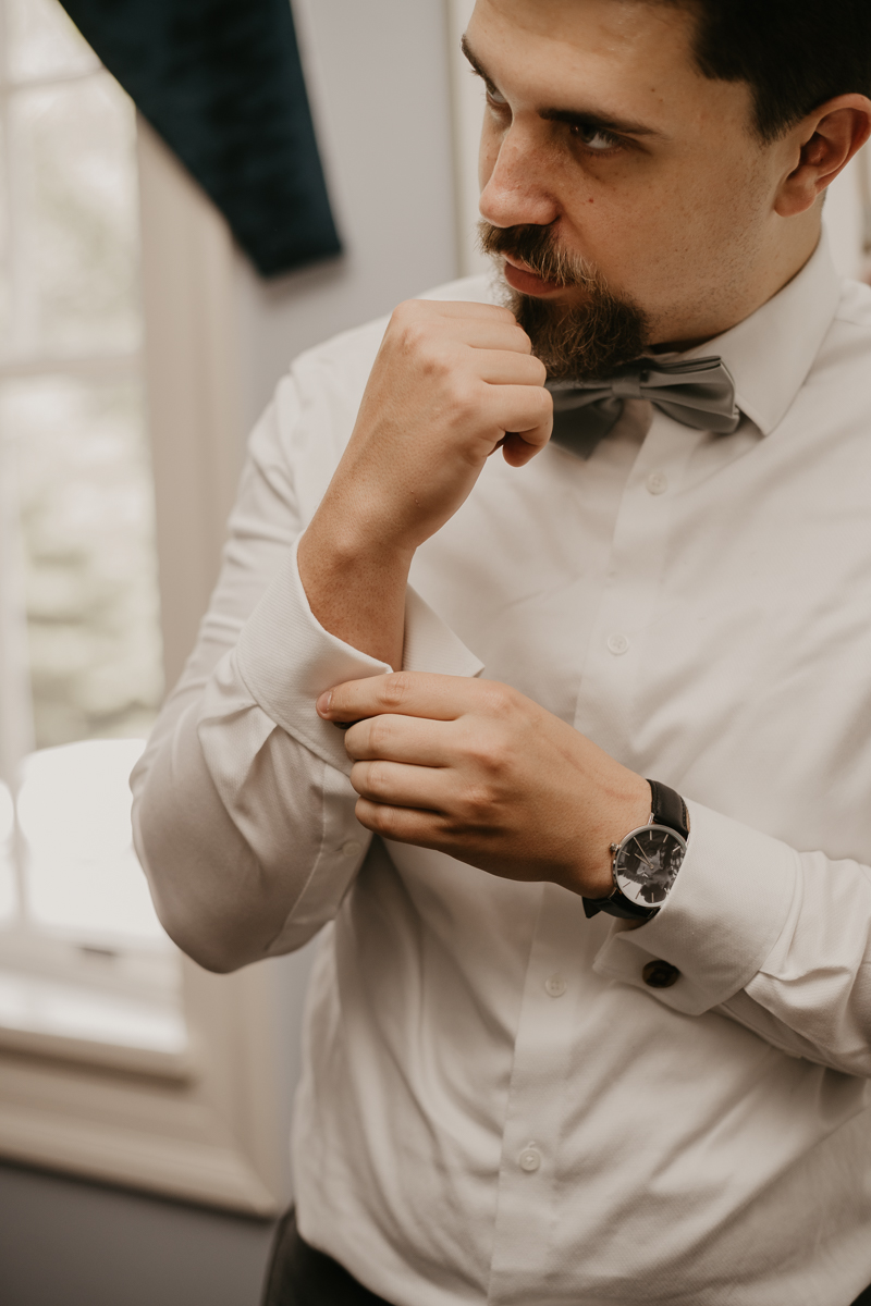 A groom getting ready at the Liriodendron Mansion in Bel Air, Maryland by Britney Clause Photography