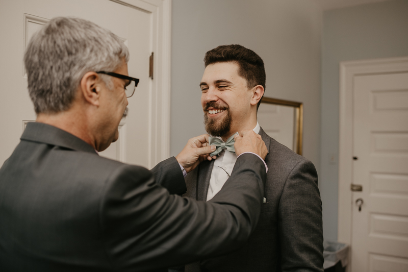 A groom getting ready at the Liriodendron Mansion in Bel Air, Maryland by Britney Clause Photography