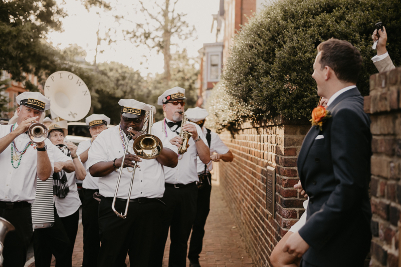 A high energy wedding march through the streets of Annapolis, Maryland by Naptown Brass Band from the William Paca House to Ego Alley by Britney Clause Photography