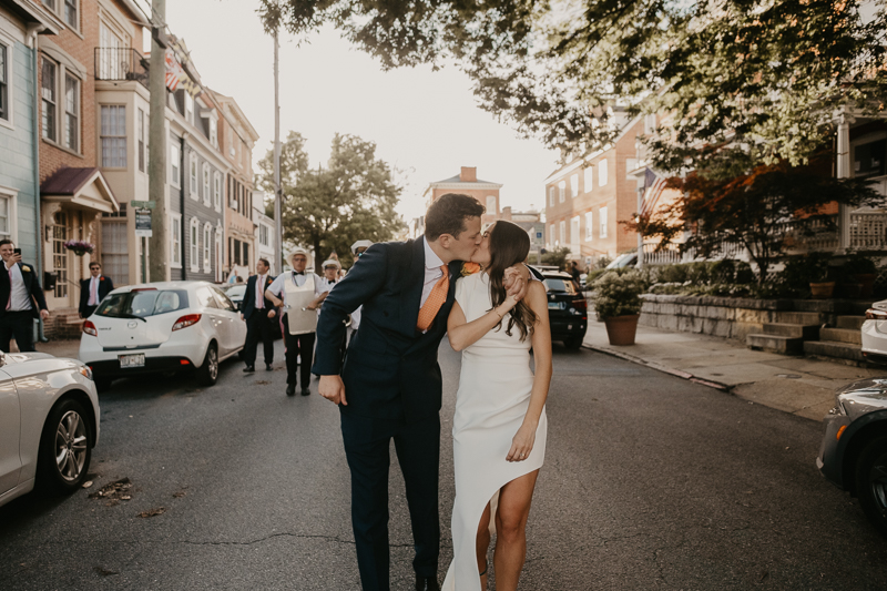 A high energy wedding march through the streets of Annapolis, Maryland by Naptown Brass Band from the William Paca House to Ego Alley by Britney Clause Photography