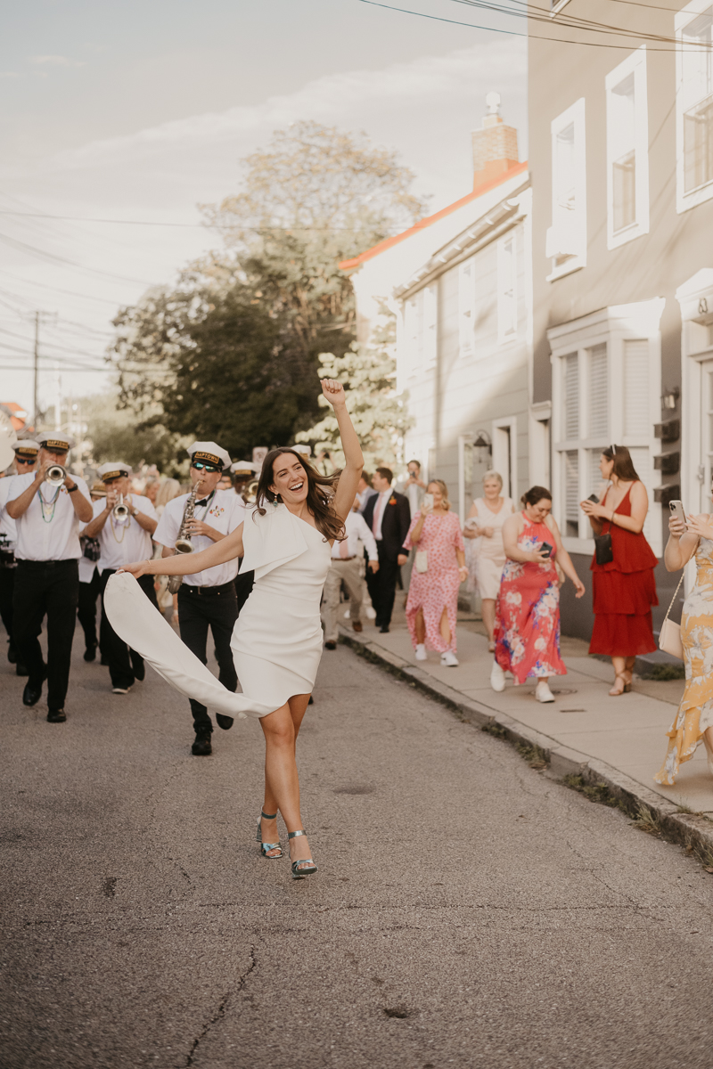 A high energy wedding march through the streets of Annapolis, Maryland by Naptown Brass Band from the William Paca House to Ego Alley by Britney Clause Photography