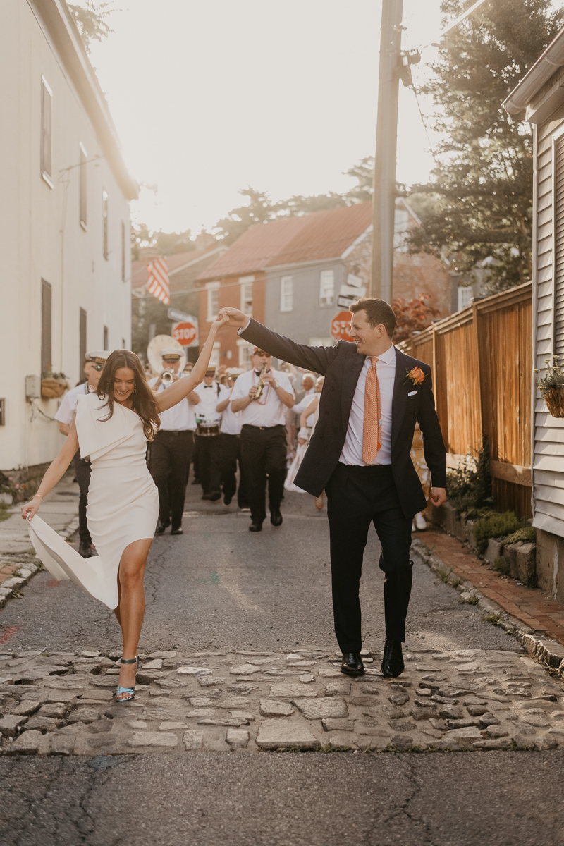 A high energy wedding march through the streets of Annapolis, Maryland by Naptown Brass Band from the William Paca House to Ego Alley by Britney Clause Photography