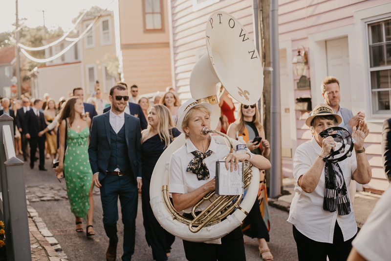 A high energy wedding march through the streets of Annapolis, Maryland by Naptown Brass Band from the William Paca House to Ego Alley by Britney Clause Photography