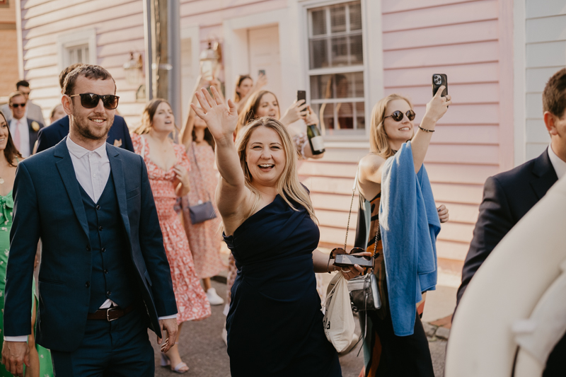 A high energy wedding march through the streets of Annapolis, Maryland by Naptown Brass Band from the William Paca House to Ego Alley by Britney Clause Photography