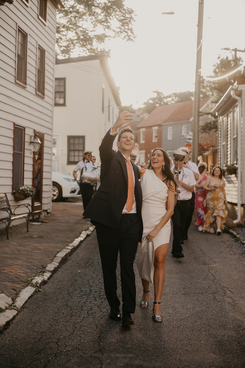 A high energy wedding march through the streets of Annapolis, Maryland by Naptown Brass Band from the William Paca House to Ego Alley by Britney Clause Photography