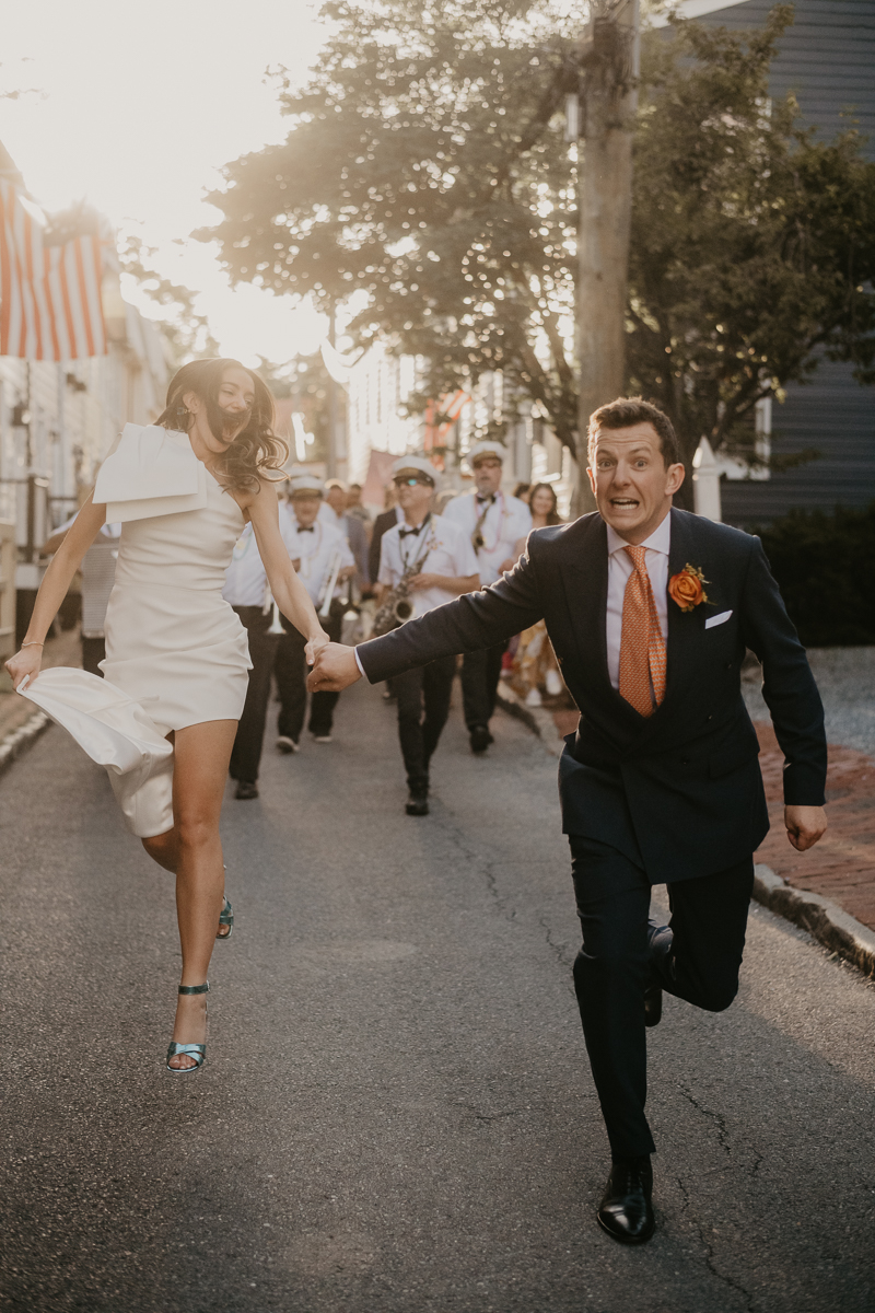 A high energy wedding march through the streets of Annapolis, Maryland by Naptown Brass Band from the William Paca House to Ego Alley by Britney Clause Photography