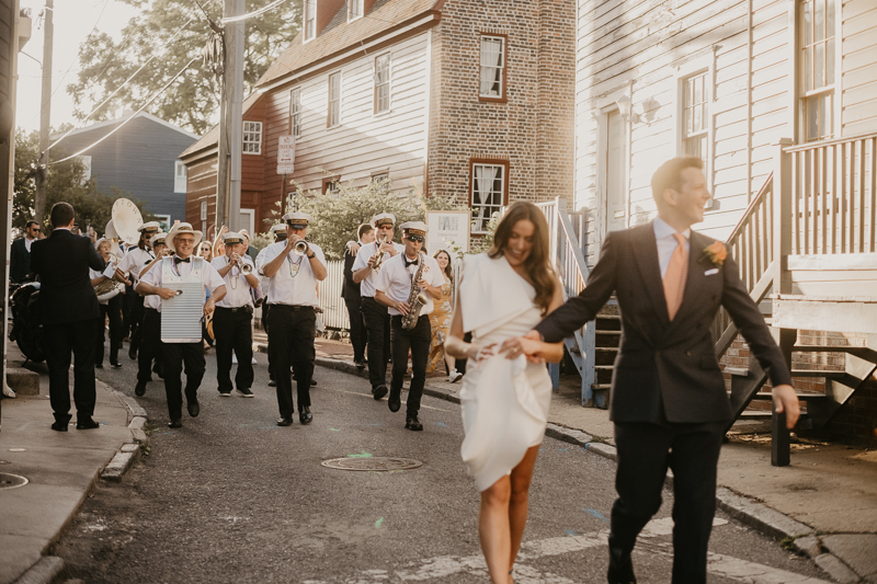 A high energy wedding march through the streets of Annapolis, Maryland by Naptown Brass Band from the William Paca House to Ego Alley by Britney Clause Photography