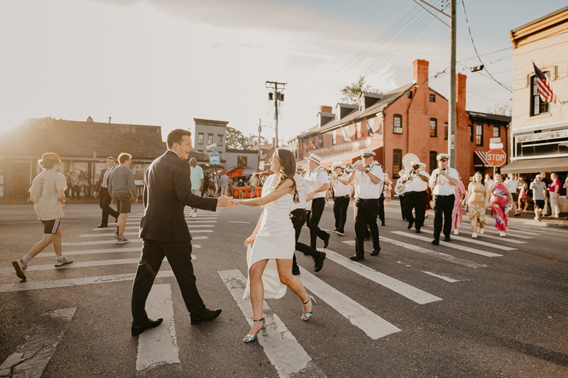 A high energy wedding march through the streets of Annapolis, Maryland by Naptown Brass Band from the William Paca House to Ego Alley by Britney Clause Photography