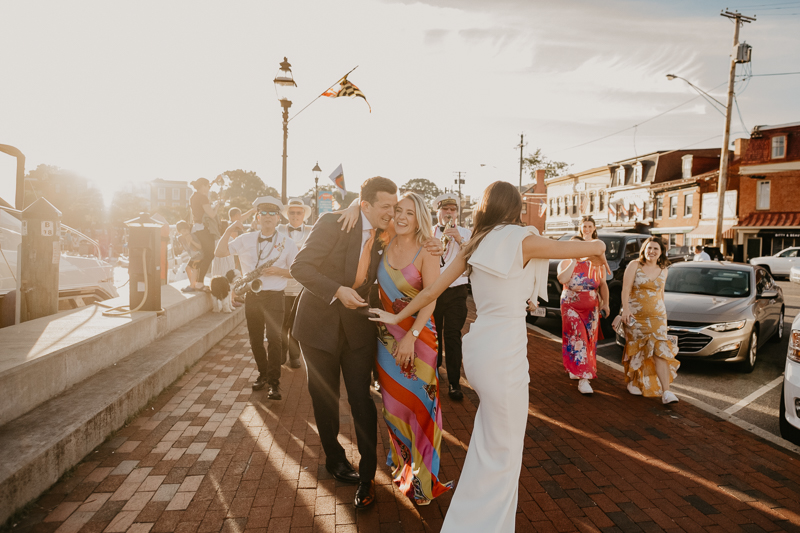 A high energy wedding march through the streets of Annapolis, Maryland by Naptown Brass Band from the William Paca House to Ego Alley by Britney Clause Photography