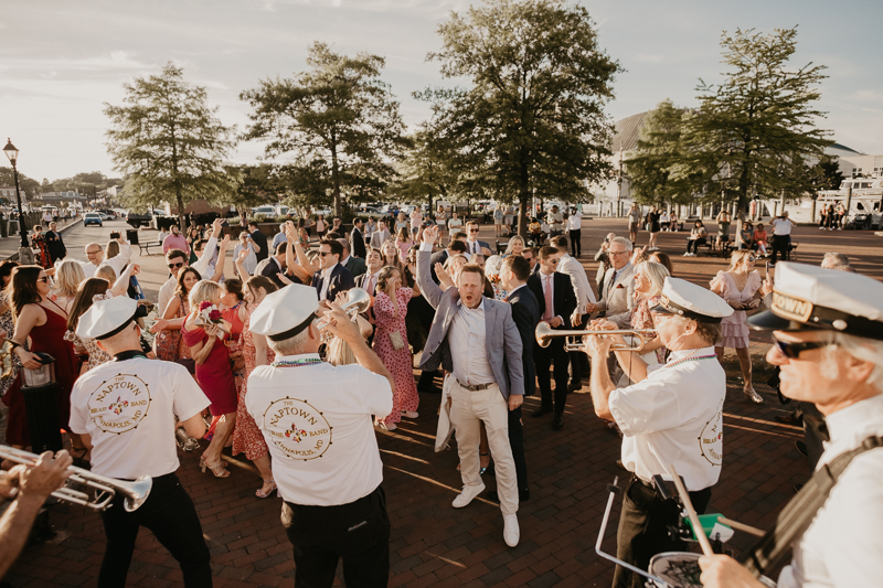 A high energy wedding march through the streets of Annapolis, Maryland by Naptown Brass Band from the William Paca House to Ego Alley by Britney Clause Photography