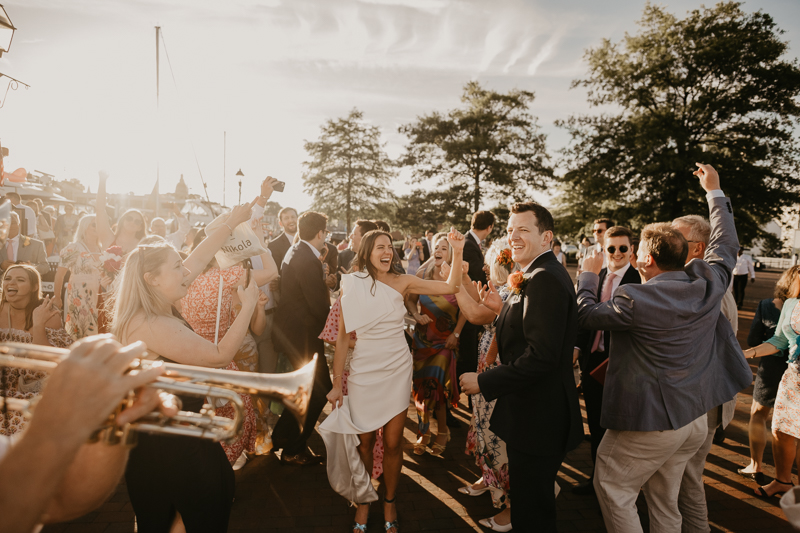 A high energy wedding march through the streets of Annapolis, Maryland by Naptown Brass Band from the William Paca House to Ego Alley by Britney Clause Photography