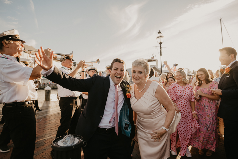 A high energy wedding march through the streets of Annapolis, Maryland by Naptown Brass Band from the William Paca House to Ego Alley by Britney Clause Photography