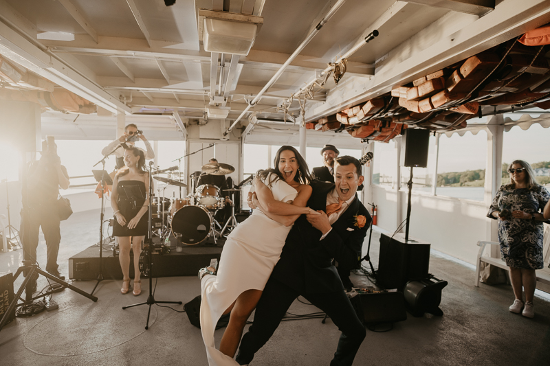 An exciting evening wedding reception by Watershed Entertainment and Timmie Metz Band on the Harbor Queen boat in Annapolis, Maryland by Britney Clause Photography