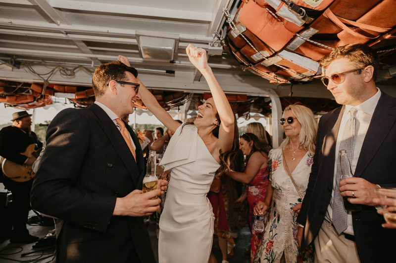 An exciting evening wedding reception by Watershed Entertainment and Timmie Metz Band on the Harbor Queen boat in Annapolis, Maryland by Britney Clause Photography