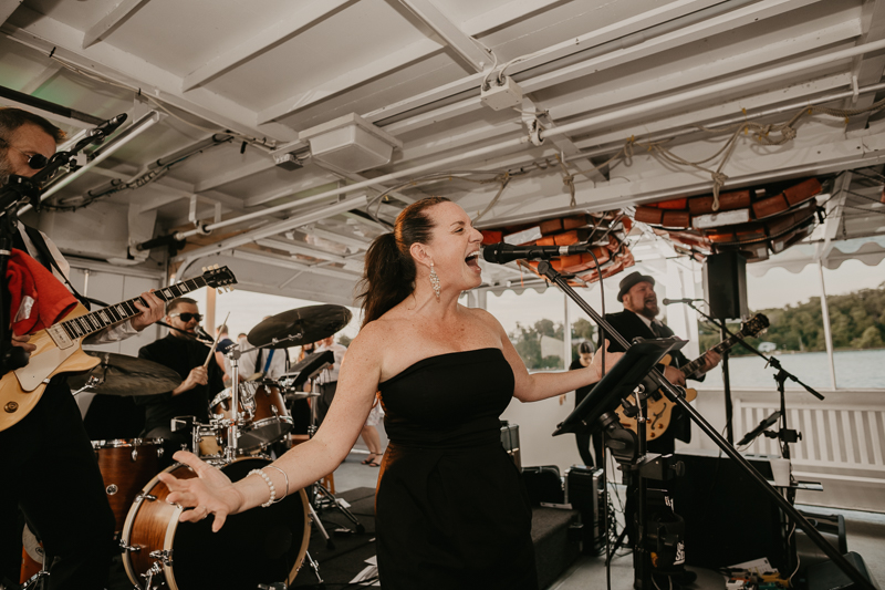 An exciting evening wedding reception by Watershed Entertainment and Timmie Metz Band on the Harbor Queen boat in Annapolis, Maryland by Britney Clause Photography