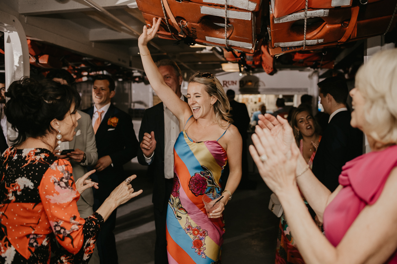 An exciting evening wedding reception by Watershed Entertainment and Timmie Metz Band on the Harbor Queen boat in Annapolis, Maryland by Britney Clause Photography