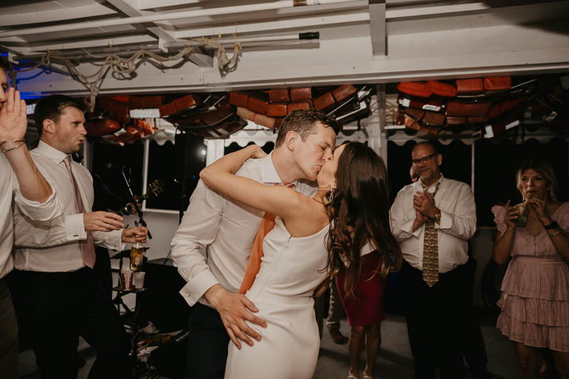 An exciting evening wedding reception by Watershed Entertainment and Timmie Metz Band on the Harbor Queen boat in Annapolis, Maryland by Britney Clause Photography