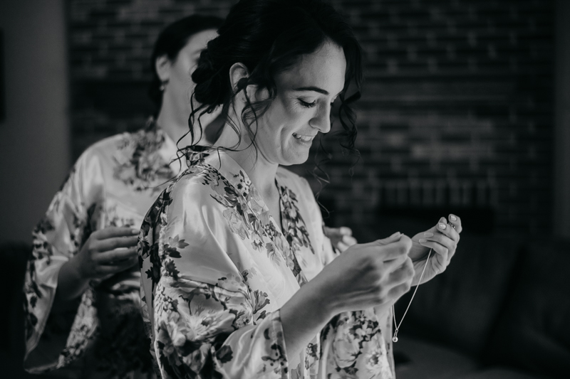 A bride getting ready with hair and makeup by Updos for Idos at a private residence for an Ellicott City, Maryland wedding by Britney Clause Photography