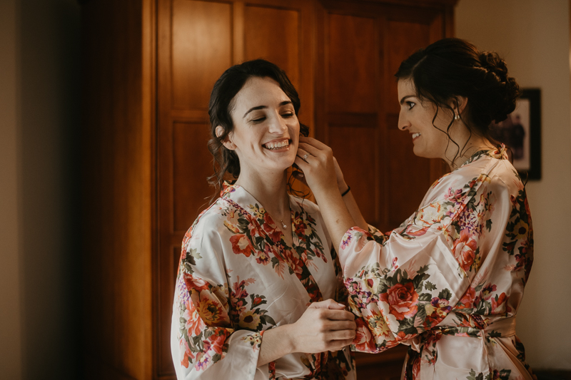A bride getting ready with hair and makeup by Updos for Idos at a private residence for an Ellicott City, Maryland wedding by Britney Clause Photography