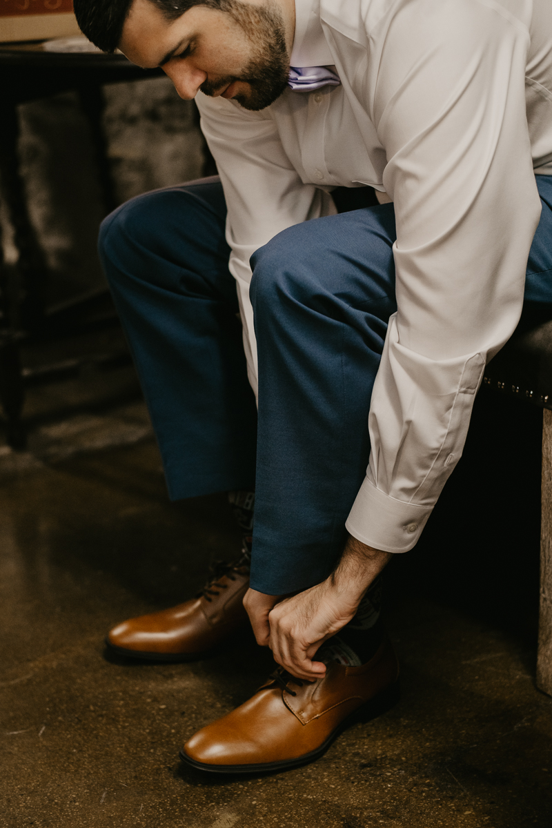 A groom getting ready at Main Street Ballroom in Ellicott City, Maryland by Britney Clause Photography