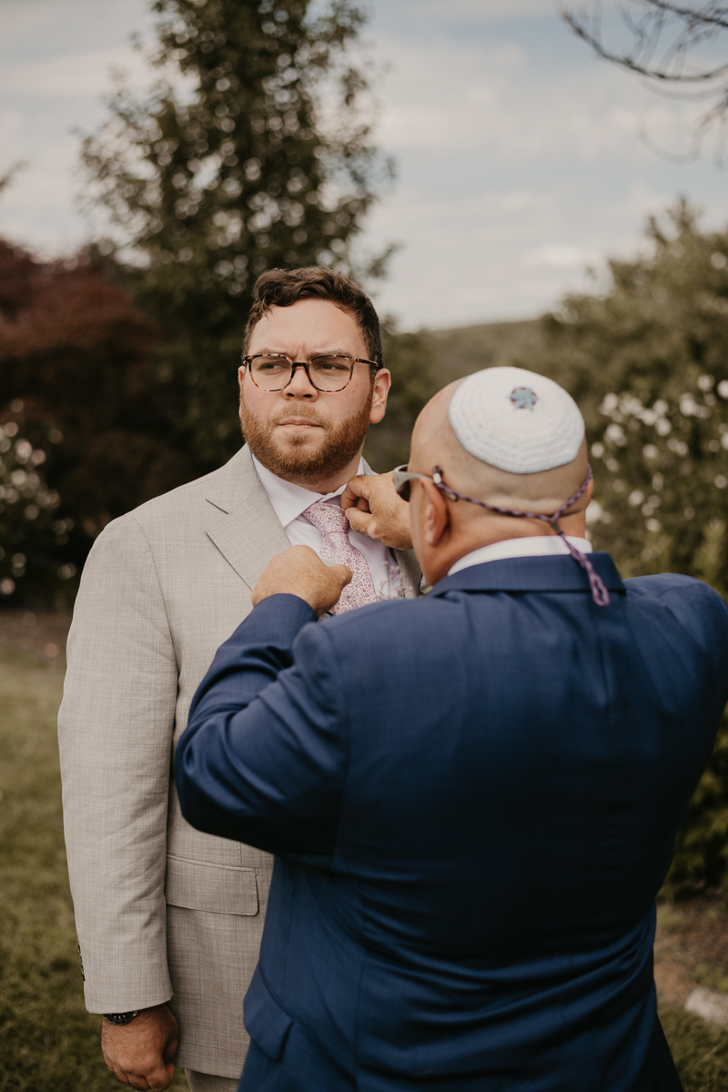 A groom getting ready at Dulany's Overlook in Frederick, Maryland by Britney Clause Photography
