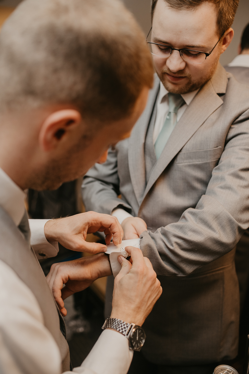 A groom getting ready for his wedding at Celebrations at the Bay in Pasadena, Maryland by Britney Clause Photography