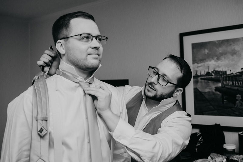 A groom getting ready for his wedding at Celebrations at the Bay in Pasadena, Maryland by Britney Clause Photography