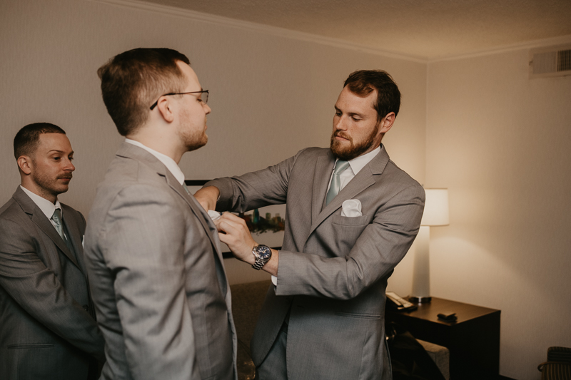 A groom getting ready for his wedding at Celebrations at the Bay in Pasadena, Maryland by Britney Clause Photography