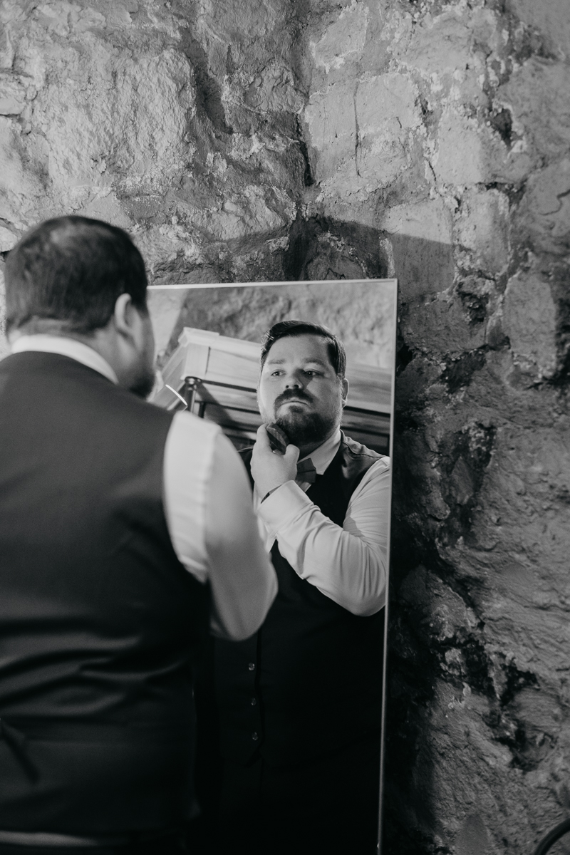 A groom getting ready at Main Street Ballroom in Ellicott City, Maryland by Britney Clause Photography