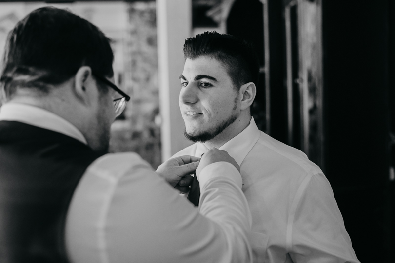 A groom getting ready at Main Street Ballroom in Ellicott City, Maryland by Britney Clause Photography