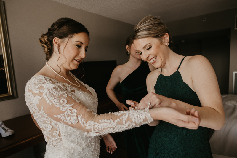 A bride getting ready at the Double Tree Hilton Hotel Baltimore for a Mt. Washington Mill Dye House in Baltimore, Maryland by Britney Clause Photography